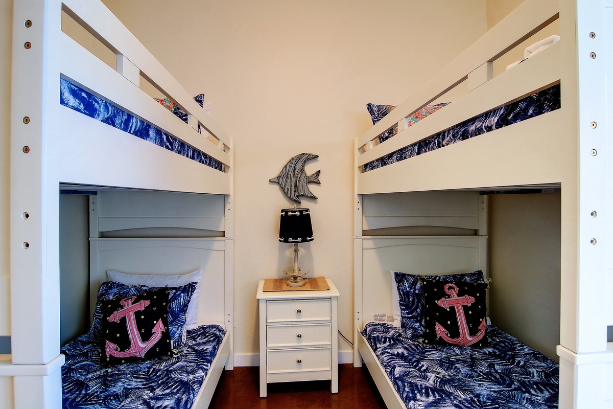 Your kids will love this charming nautical-themed room with sturdy bunk beds and playful anchor details.