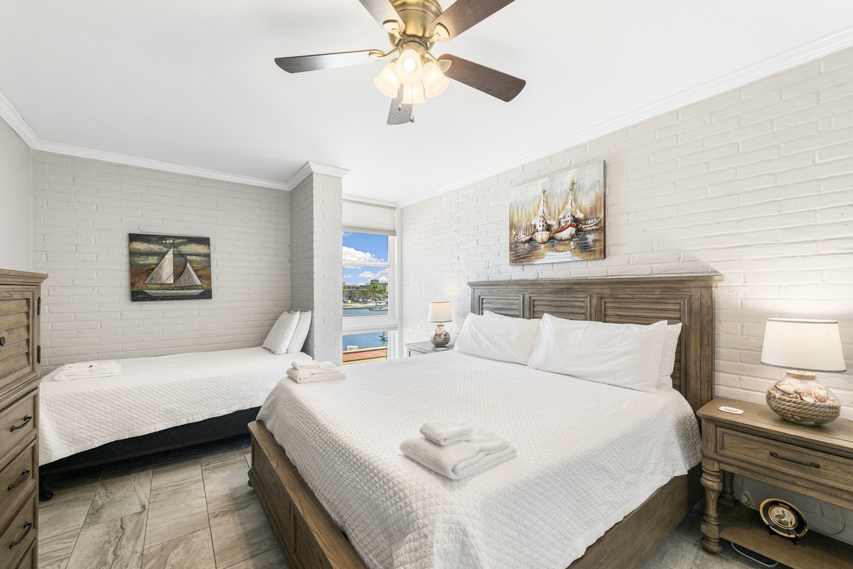 Drift off in this coastal bedroom where nautical art and waterfront views create your perfect seaside sanctuary.