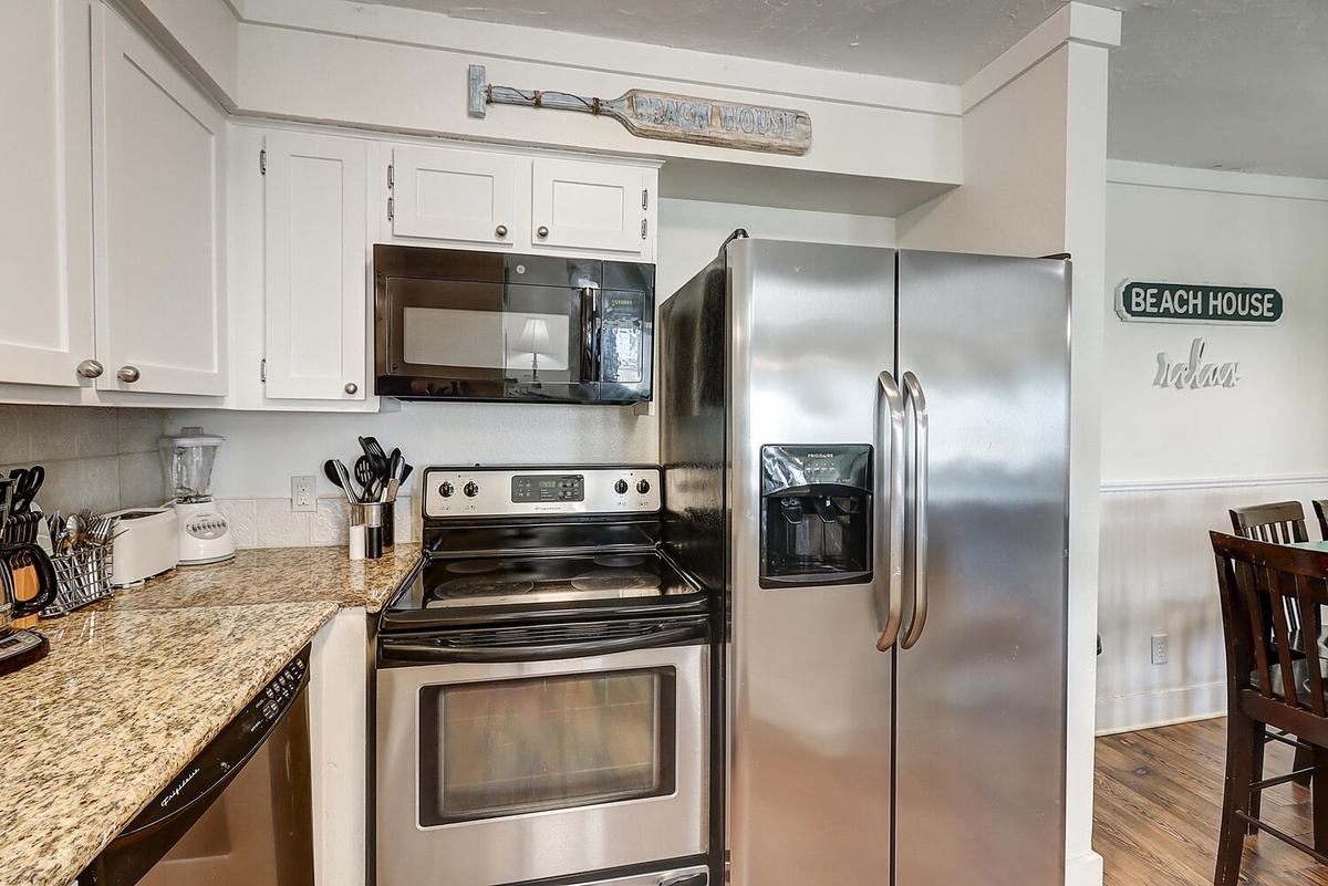 Your fully-equipped kitchen features stainless steel appliances and granite countertops, perfect for preparing meals during your beach getaway.