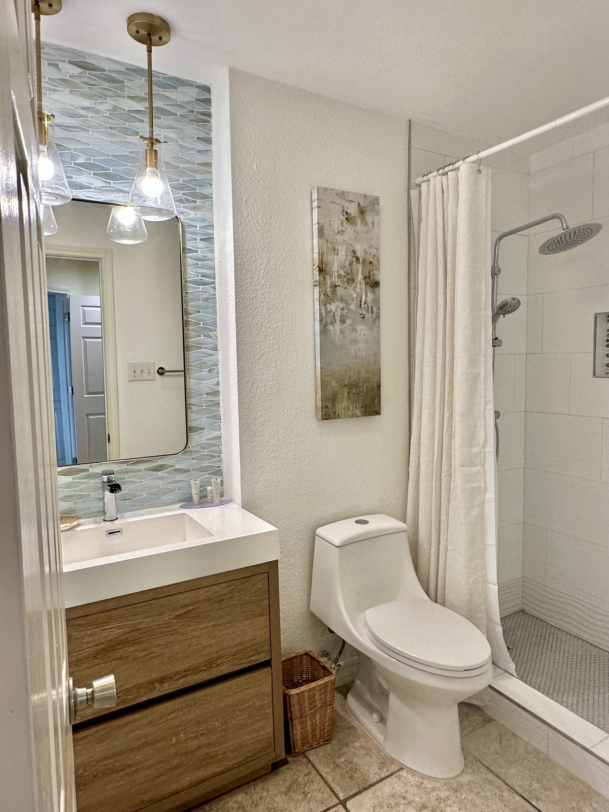 Your modern bathroom features elegant pendant lighting, a stylish vanity, and a refreshing walk-in shower to start your day.