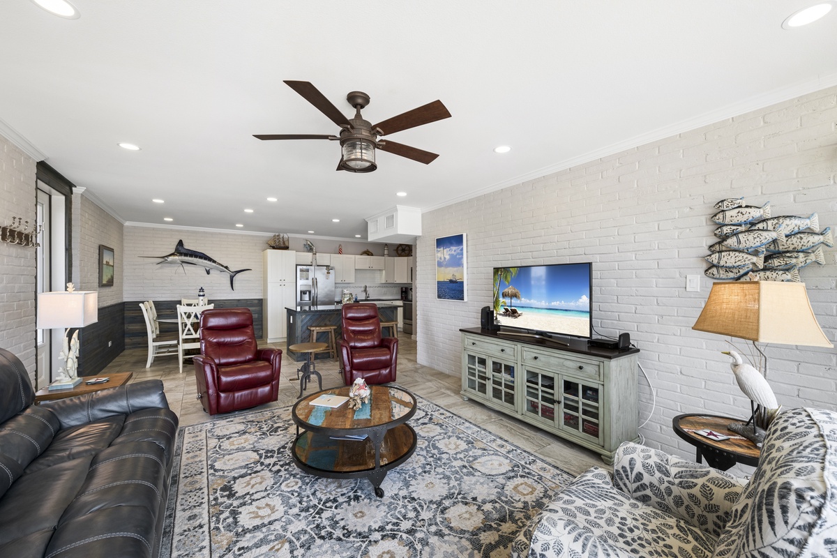Relax in your coastal-themed living space with comfortable leather seating, nautical touches, and an open layout perfect for gathering.