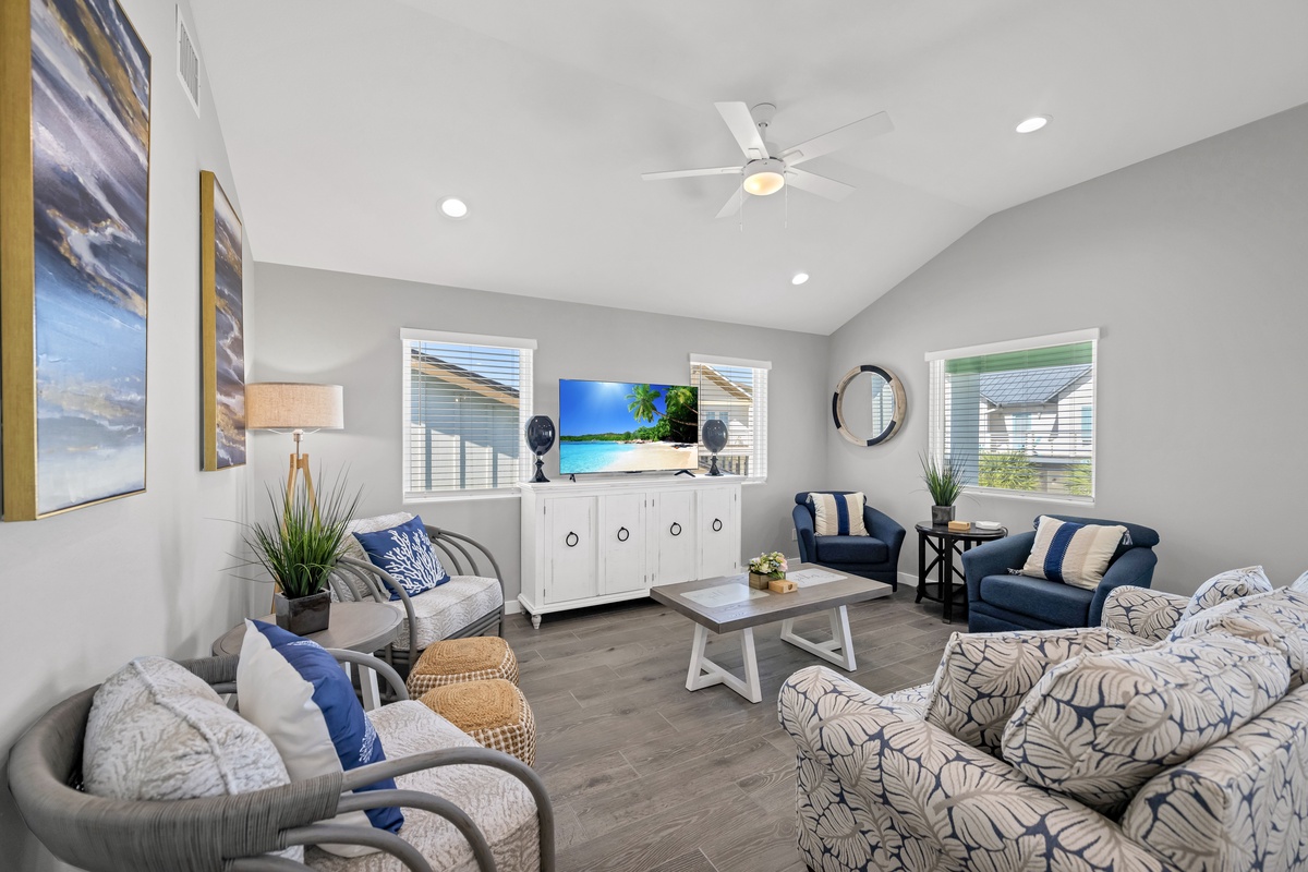 Sink into plush seating in your bright living space, where coastal blues and modern comfort create the perfect spot for your group gatherings.