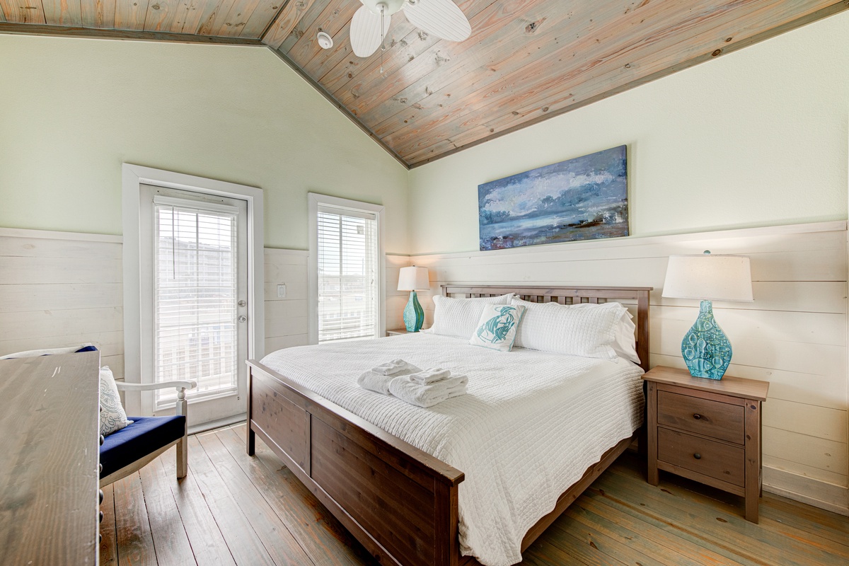 Drift into peaceful sleep in your coastal bedroom with rustic wood ceiling and crisp linens.