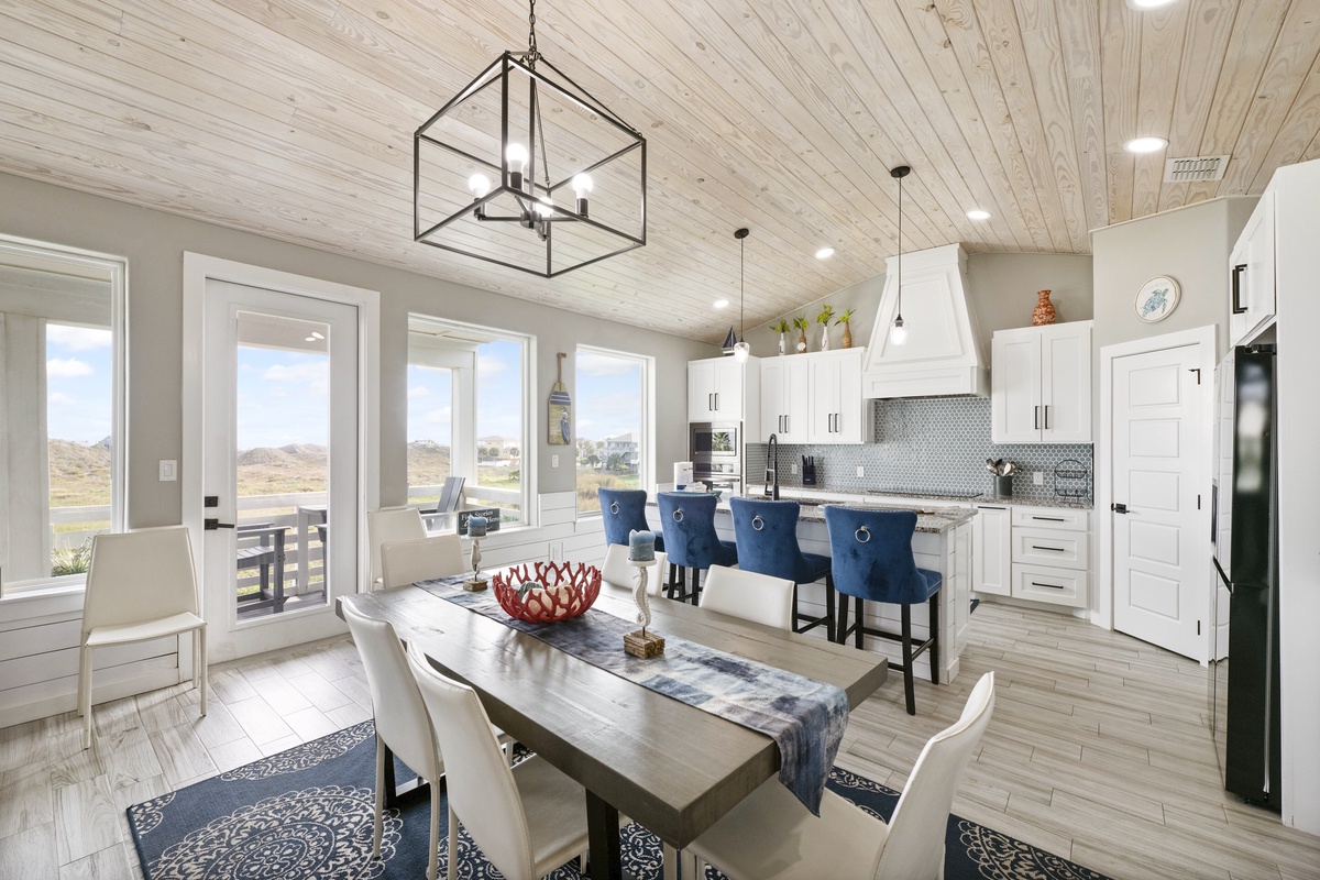 Gather around this stunning open kitchen and dining space where rustic wood meets modern elegance, perfect for creating memories together.