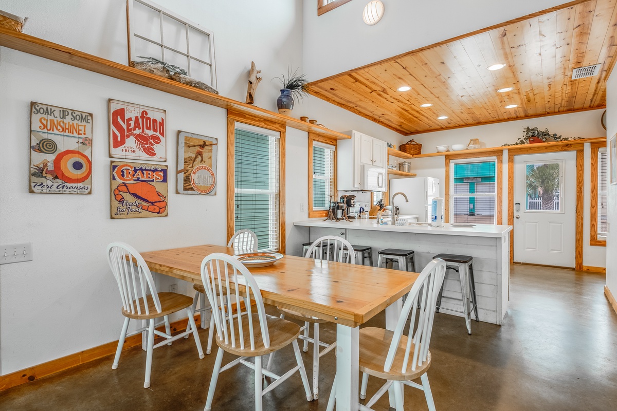 Your bright kitchen and dining space features warm wood accents, a breakfast bar, and charming coastal decor that sets the perfect mood for meals.