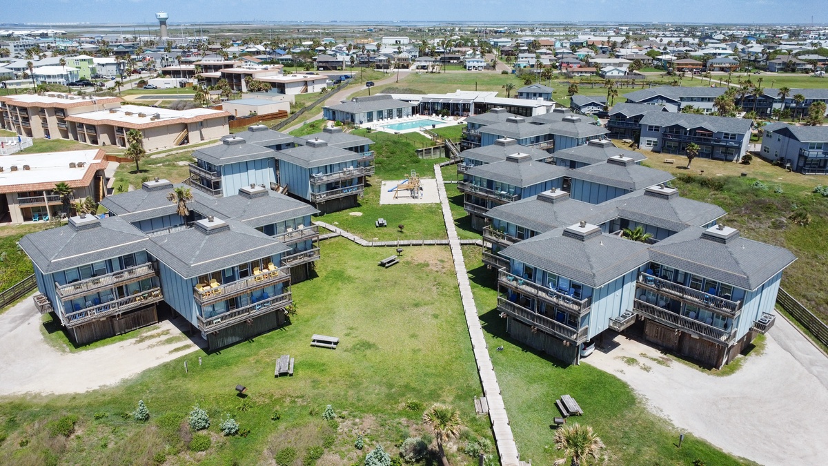 Aerial view of modern beachfront vacation properties featuring contemporary architecture in a coastal community setting.
