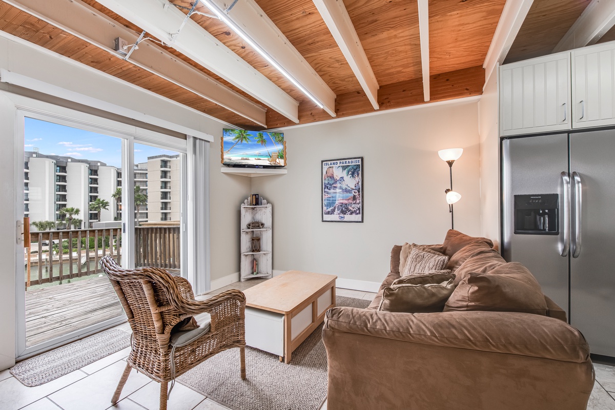 Relax in your bright living space with exposed beams, cozy leather seating, and balcony access to soak in those stunning views.