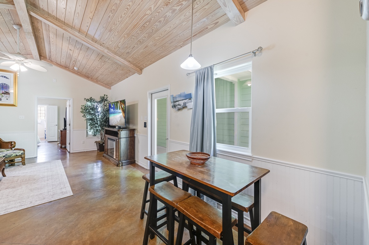 Your cozy dining nook features warm wood beams overhead and a charming table perfect for intimate meals together.