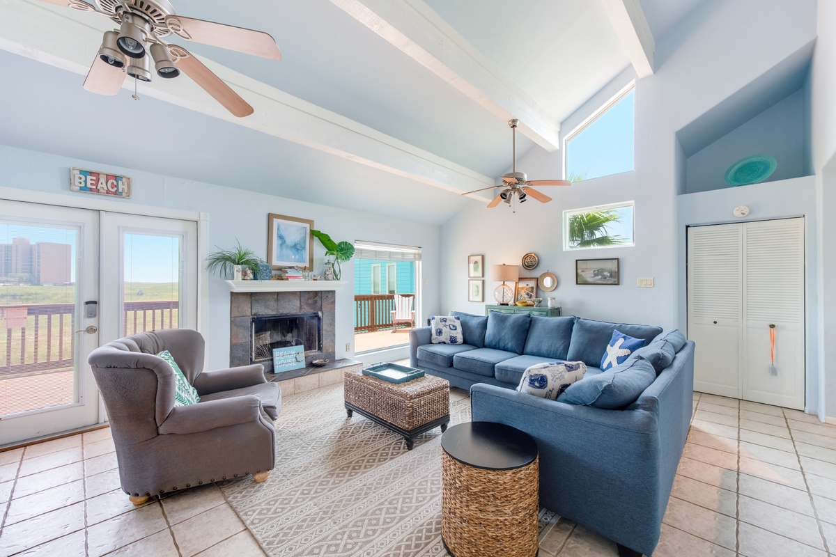 Unwind in this airy coastal living room where vaulted ceilings and ocean breezes create your perfect beach retreat.