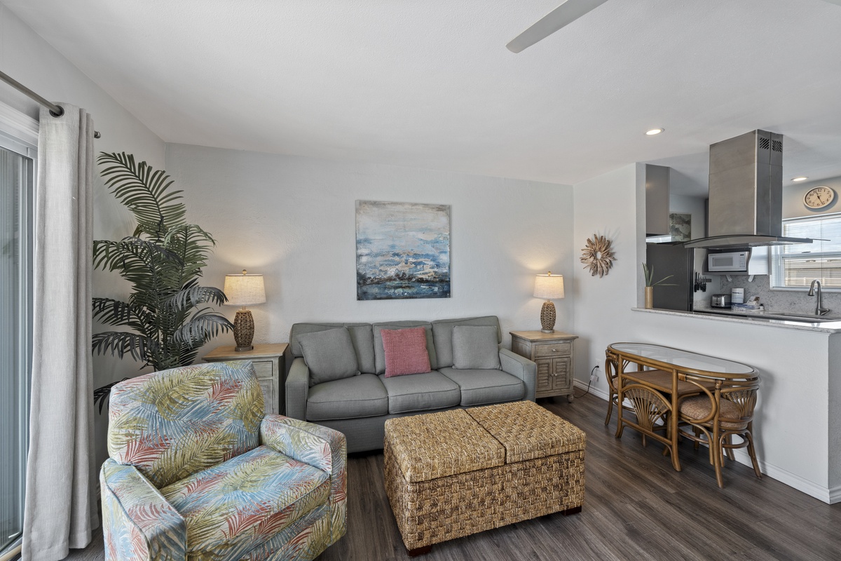 Sink into your comfortable living space where tropical touches and modern amenities create the perfect beach getaway atmosphere for relaxing evenings.