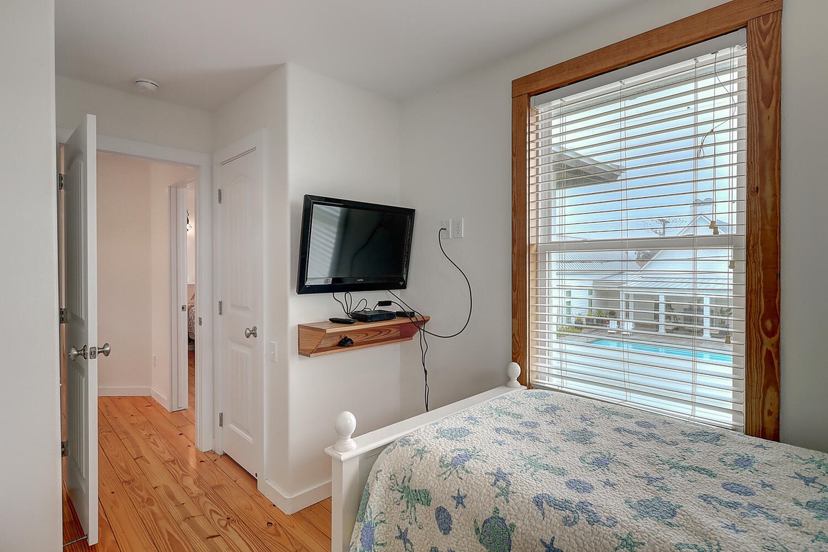 Wake up refreshed in your bright bedroom with pool views and entertainment at your fingertips.