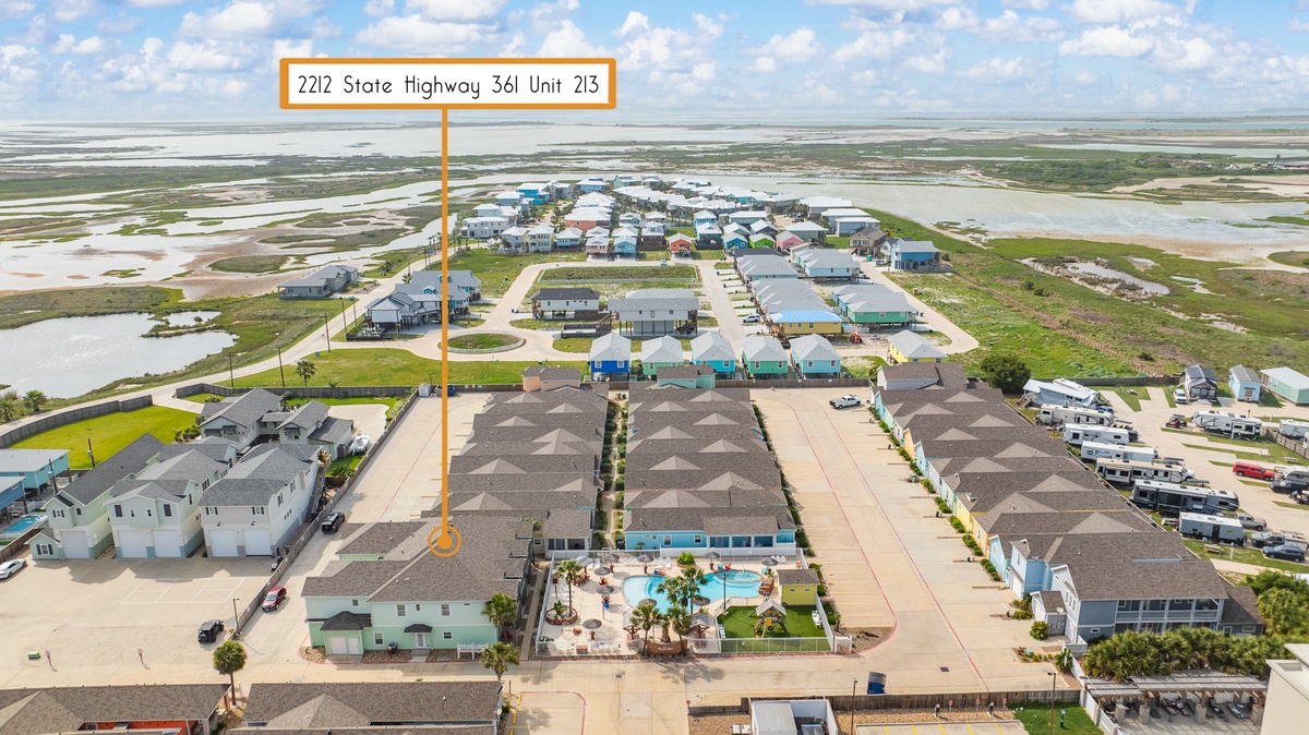 Aerial view of beachside vacation rental community with pool and beach access along State Highway 361.