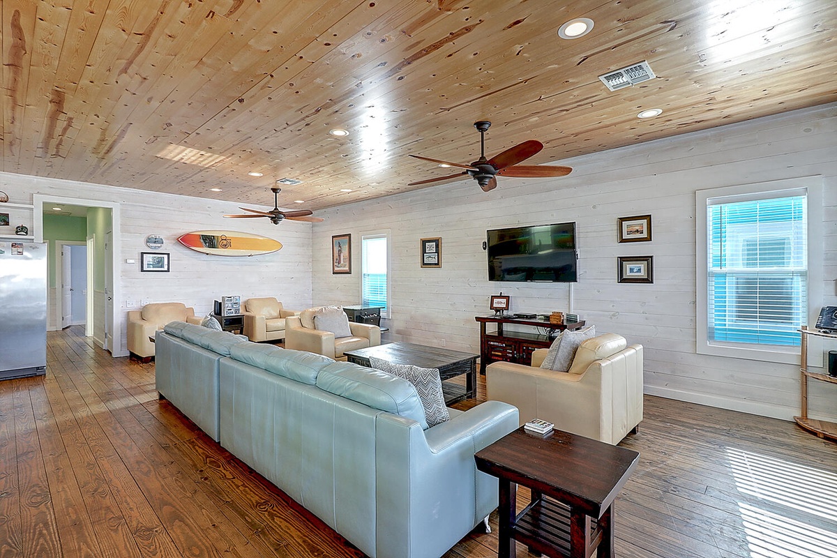 Relax in your coastal-chic living room with exposed wood ceilings, comfy seating, and ocean-inspired decor that makes every moment feel like a vacation.