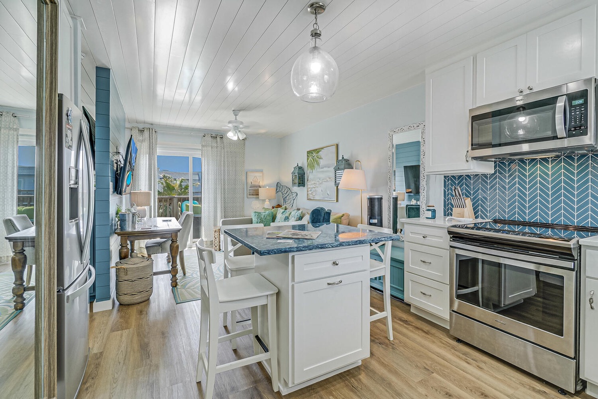 Your coastal kitchen awaits with crisp white cabinets, ocean-blue accents, and modern appliances where you'll create memorable meals.
