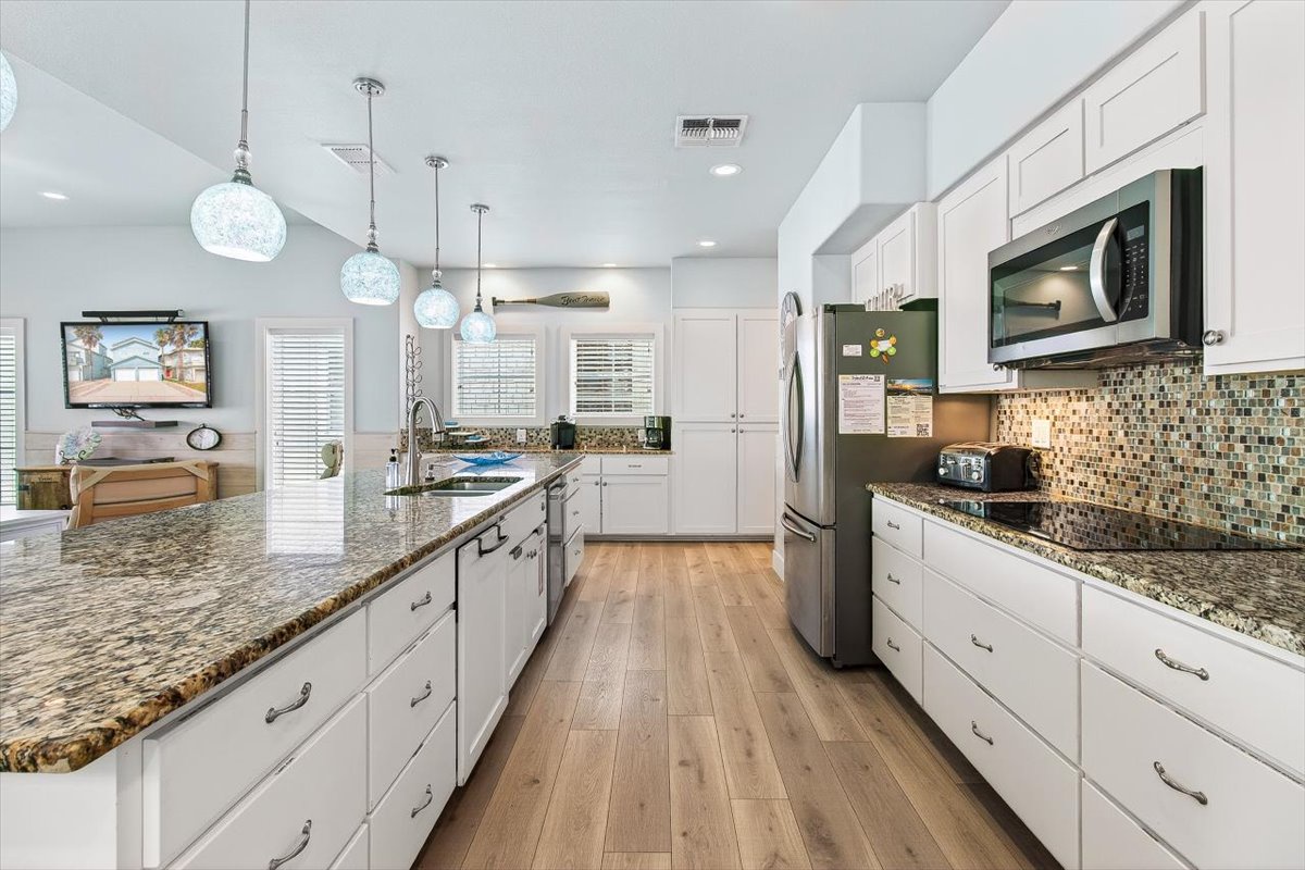 Your gourmet kitchen features granite counters, modern appliances, and a beautiful mosaic backsplash - perfect for creating memorable meals together.