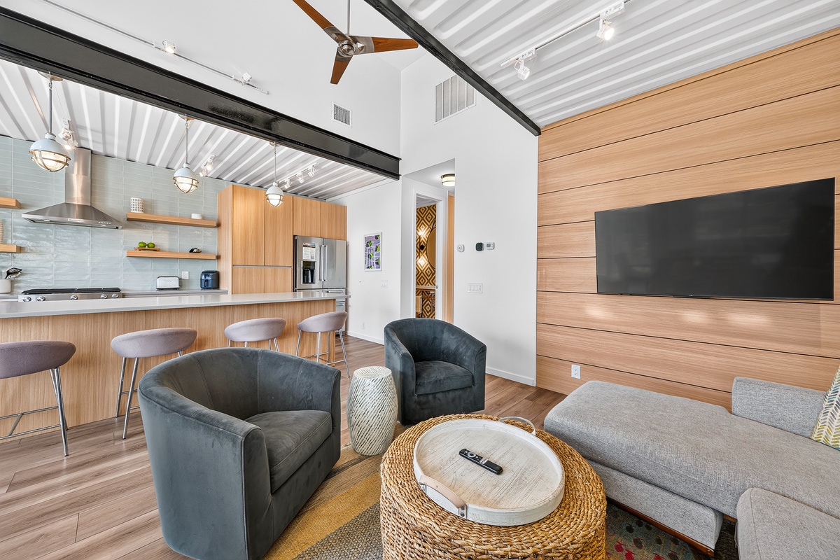 Your modern retreat blends comfort and style, with soaring ceilings, warm wood accents, and an open layout that invites you to relax in plush seating or gather around the sleek kitchen.