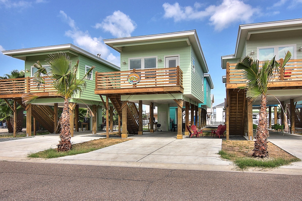 Coastal vacation homes on stilts with tropical palms and modern beach architecture create the perfect seaside getaway setting.