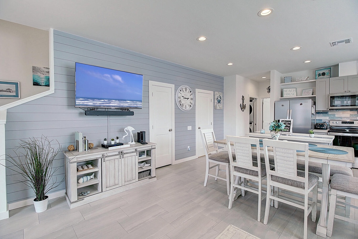 Relax in your coastal-inspired open living space where beach vibes meet modern comfort, perfect for gathering with loved ones.