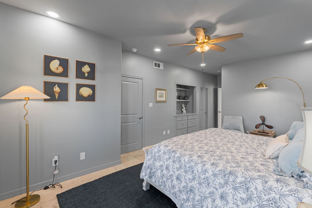 Unwind in your serene bedroom sanctuary with coastal charm, featuring elegant shell art and warm brass lighting.