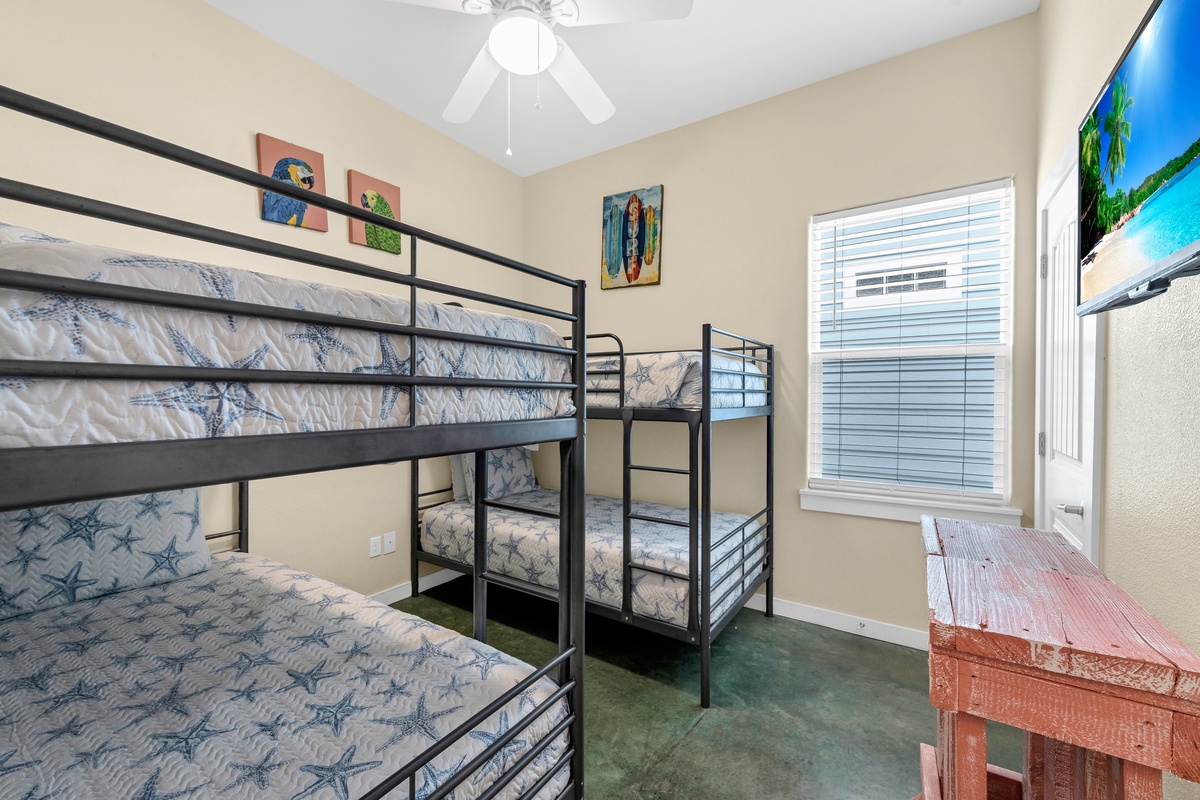 Gather your crew in this fun bunk room where everyone gets their own cozy sleeping space with beach-themed décor and cheerful coastal artwork.