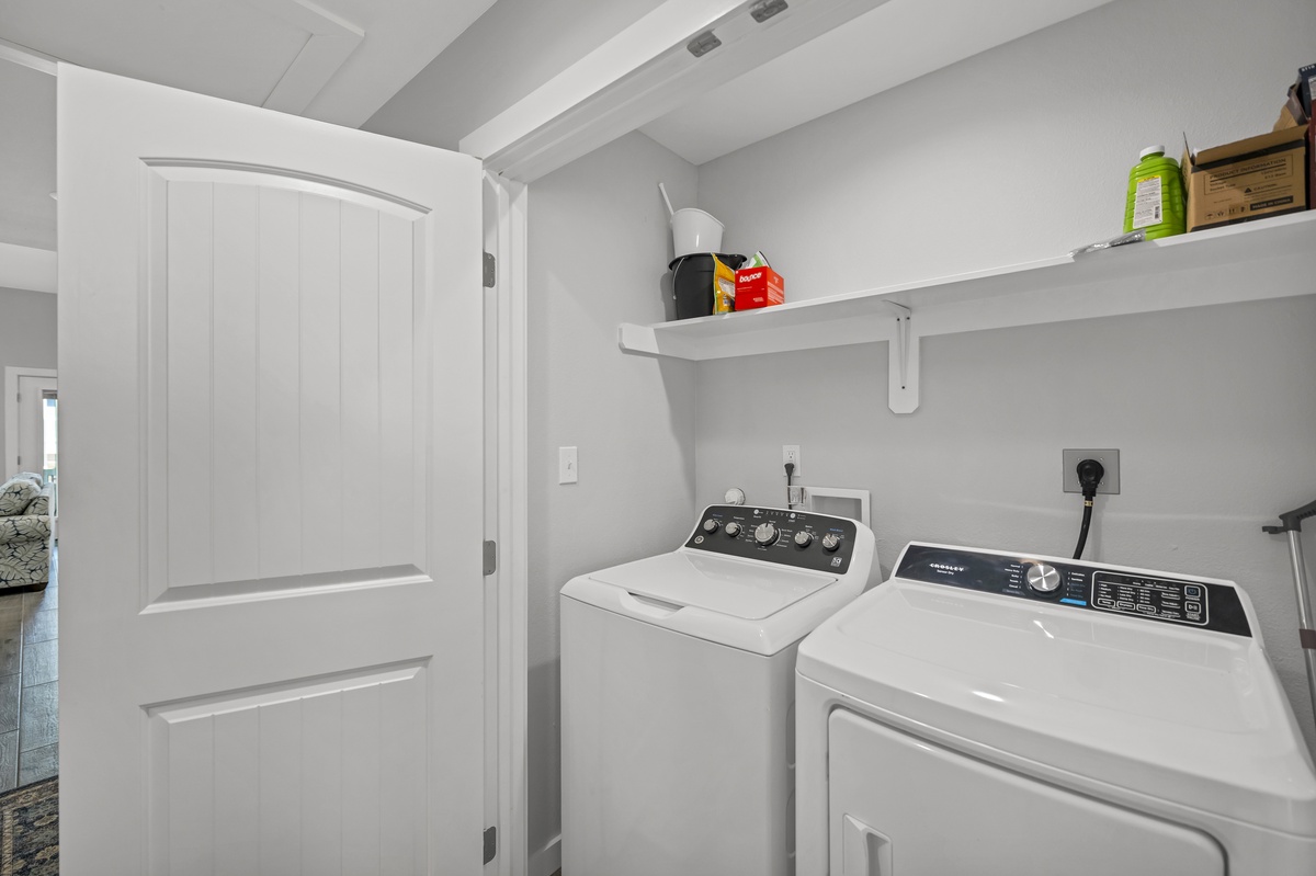Your dedicated laundry room keeps clothes fresh with a full-size washer and dryer, plus convenient shelving for supplies.