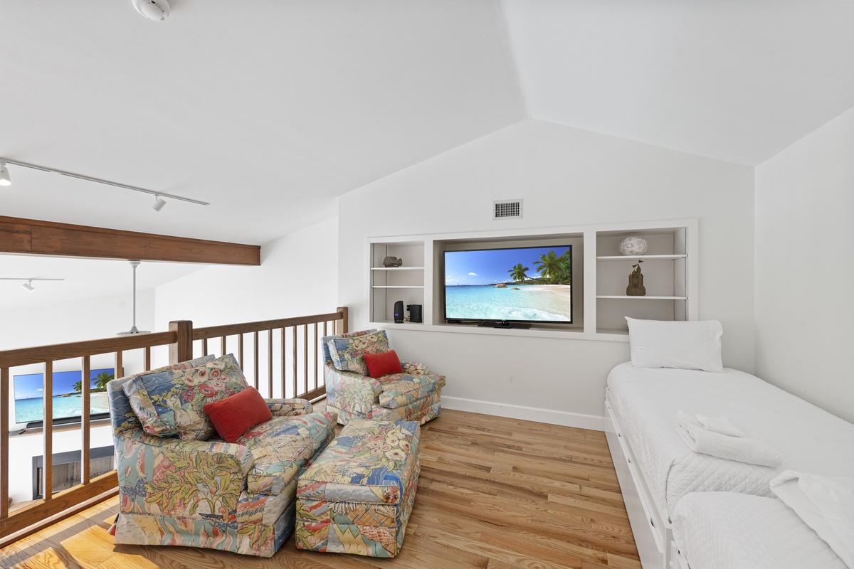 Unwind in your comfortable loft lounge with entertainment center and cozy seating overlooking the scenic area below.