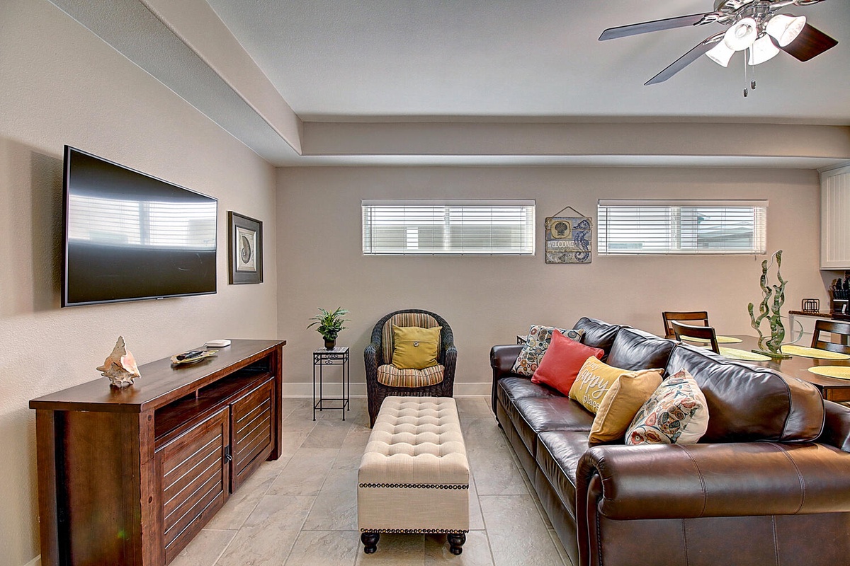 Sink into rich leather seating and enjoy movie nights on your large flat-screen TV in this cozy living room.