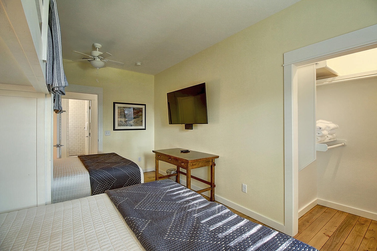 Relax in your bright bedroom with twin beds, work desk, flat-screen TV, and walk-in closet for all your belongings.