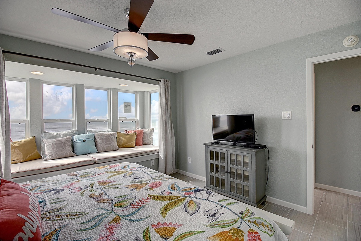 Cozy bedroom with ocean views from your window seat. Ceiling fan keeps you comfortable while TV entertains on quiet evenings.