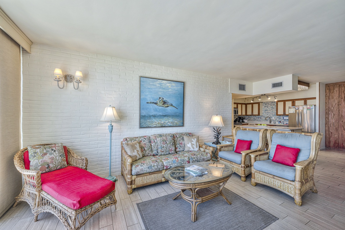 Sink into coastal elegance with wicker seating and ocean artwork creating your perfect beachside retreat.
