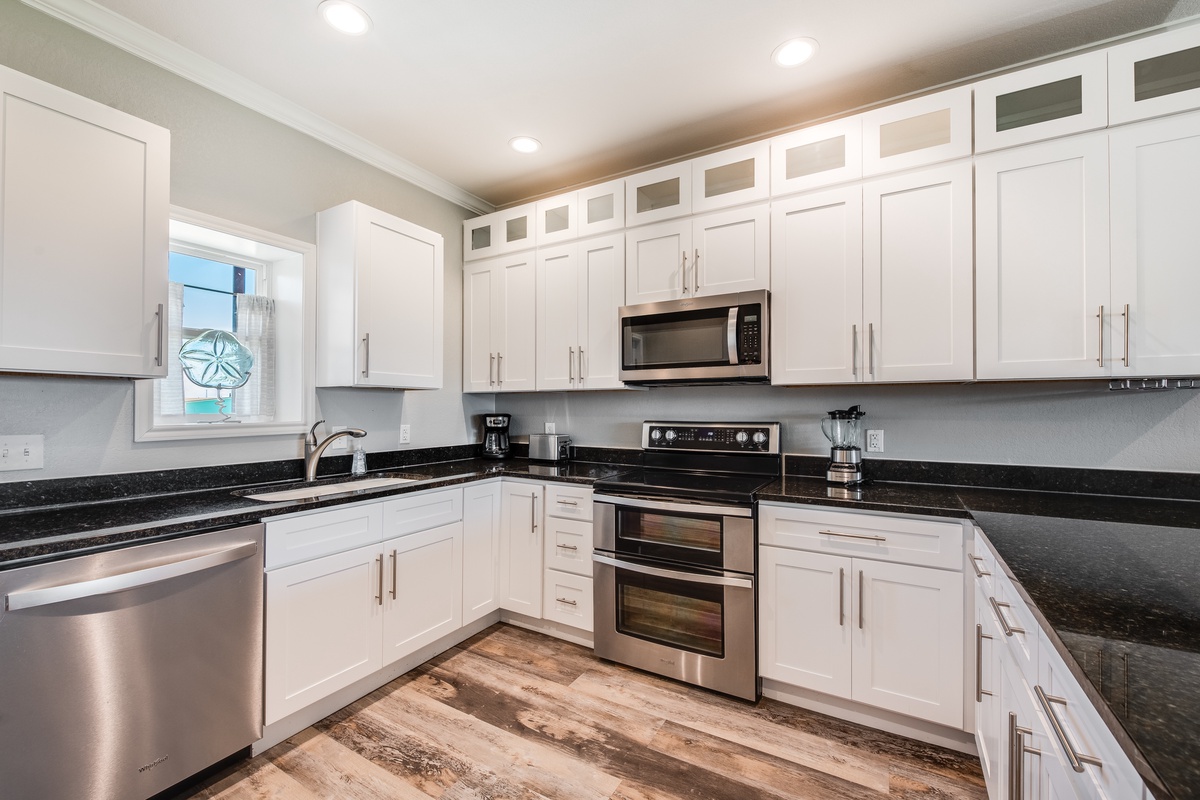 Your gourmet kitchen awaits with gleaming granite counters, crisp white cabinets, and stainless steel appliances ready for memorable meal prep.