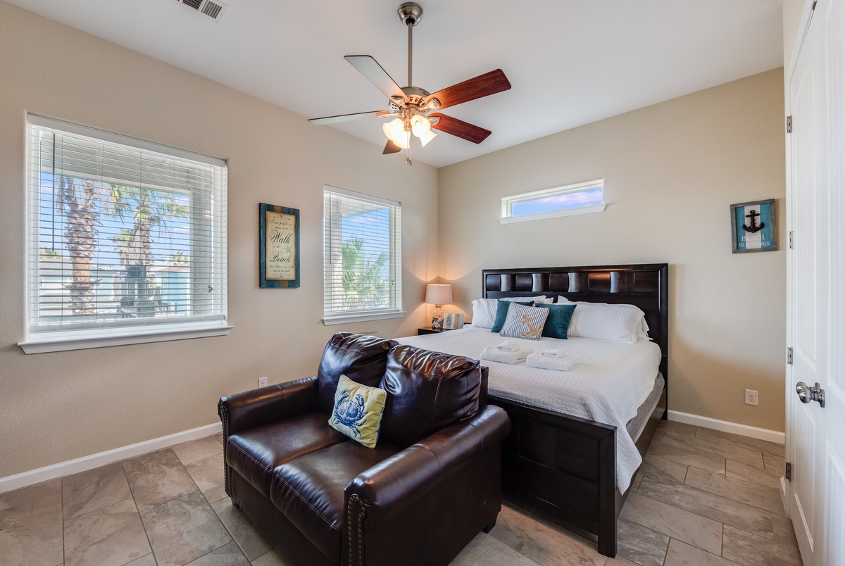 Unwind in your peaceful bedroom with crisp linens, a cozy reading chair, and warm natural light filtering through the windows.
