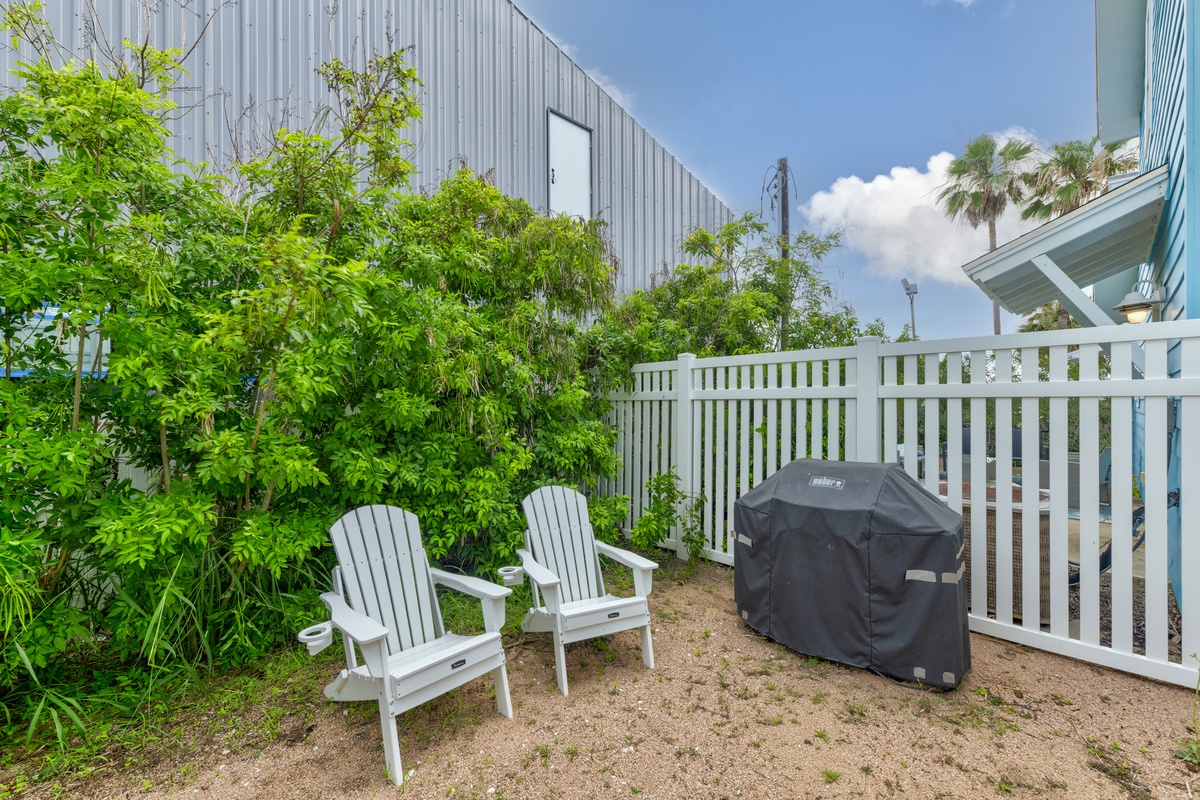 Your private backyard retreat features comfortable Adirondack chairs perfect for morning coffee or sunset relaxation, plus a covered BBQ for memorable outdoor dining.