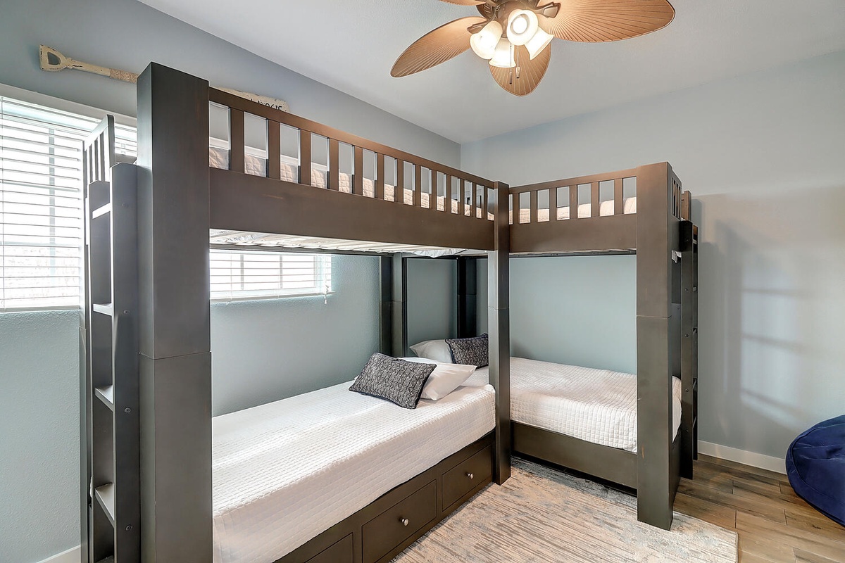 Your comfortable bunk room features custom built-in beds with cozy linens and under-bed storage, perfect for families or groups sharing space.