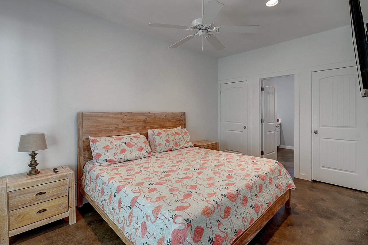 Drift off in your coastal-inspired bedroom with whimsical flamingo bedding and warm wood touches creating the perfect tropical retreat.