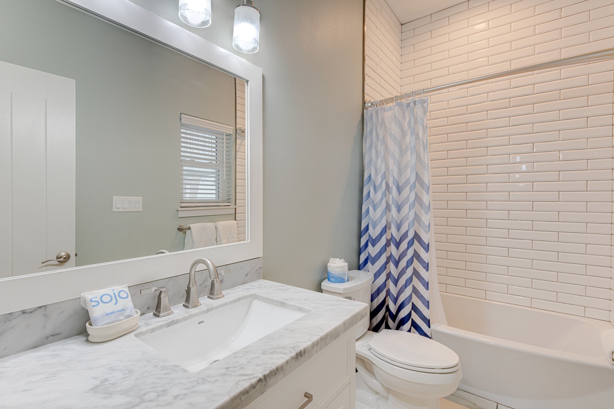 Refresh in your stylish bathroom featuring marble countertops, subway tile shower, and modern fixtures for a spa-like experience.