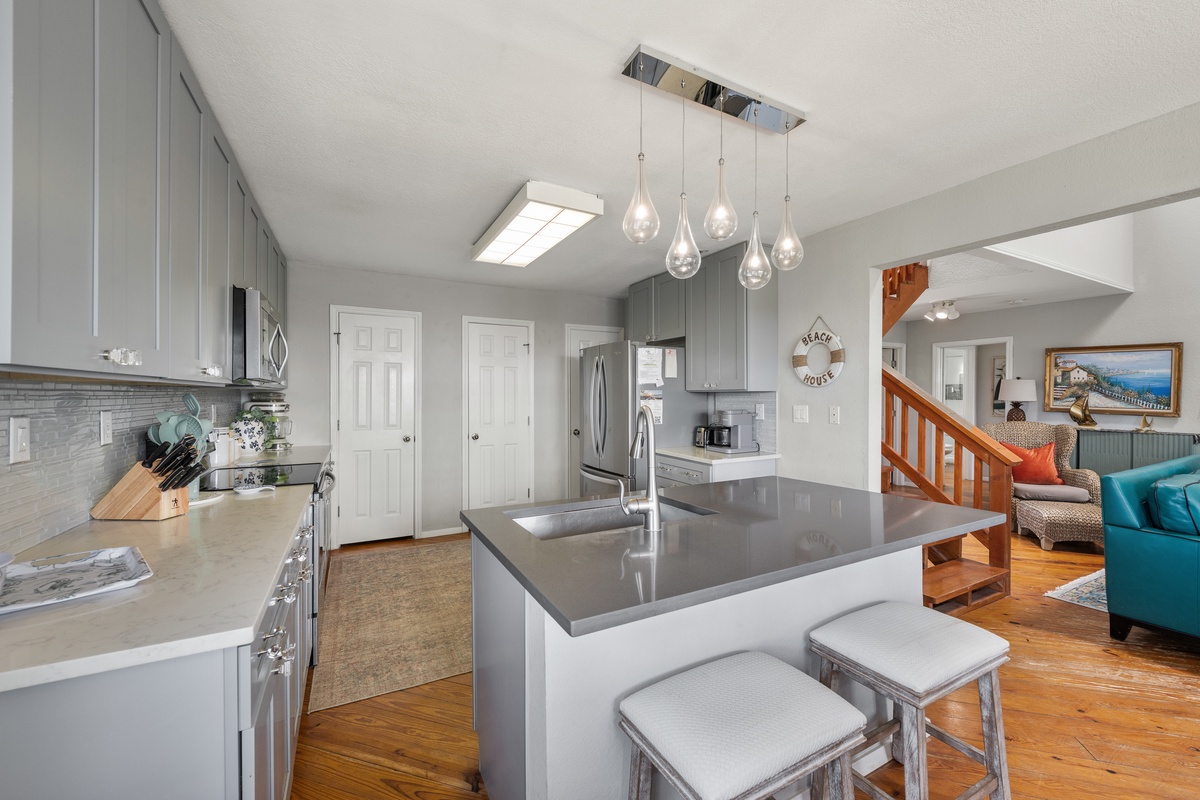 Step into your beautifully updated kitchen with a spacious island and modern finishes, where cooking becomes part of the vacation experience as the open layout flows seamlessly into the living area.