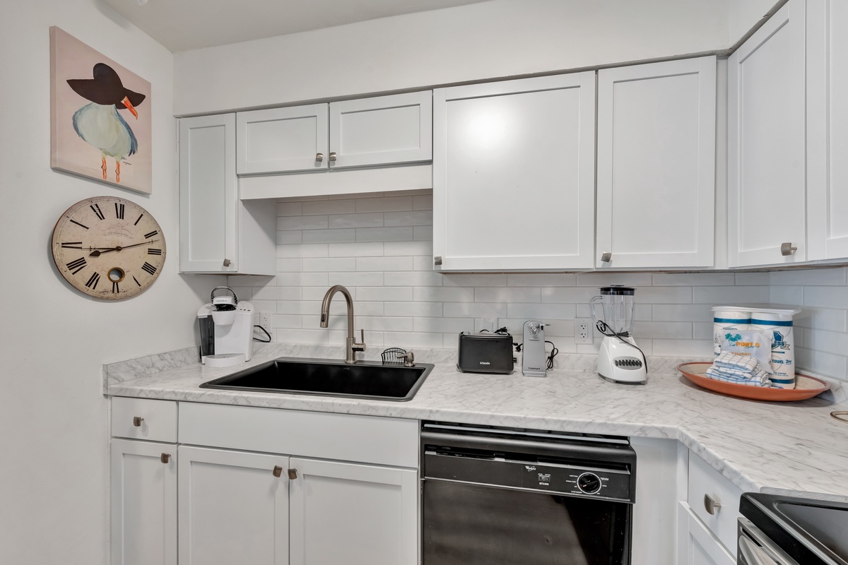Your fully equipped kitchen features marble countertops, modern appliances, and charming coastal touches that make cooking feel like home.