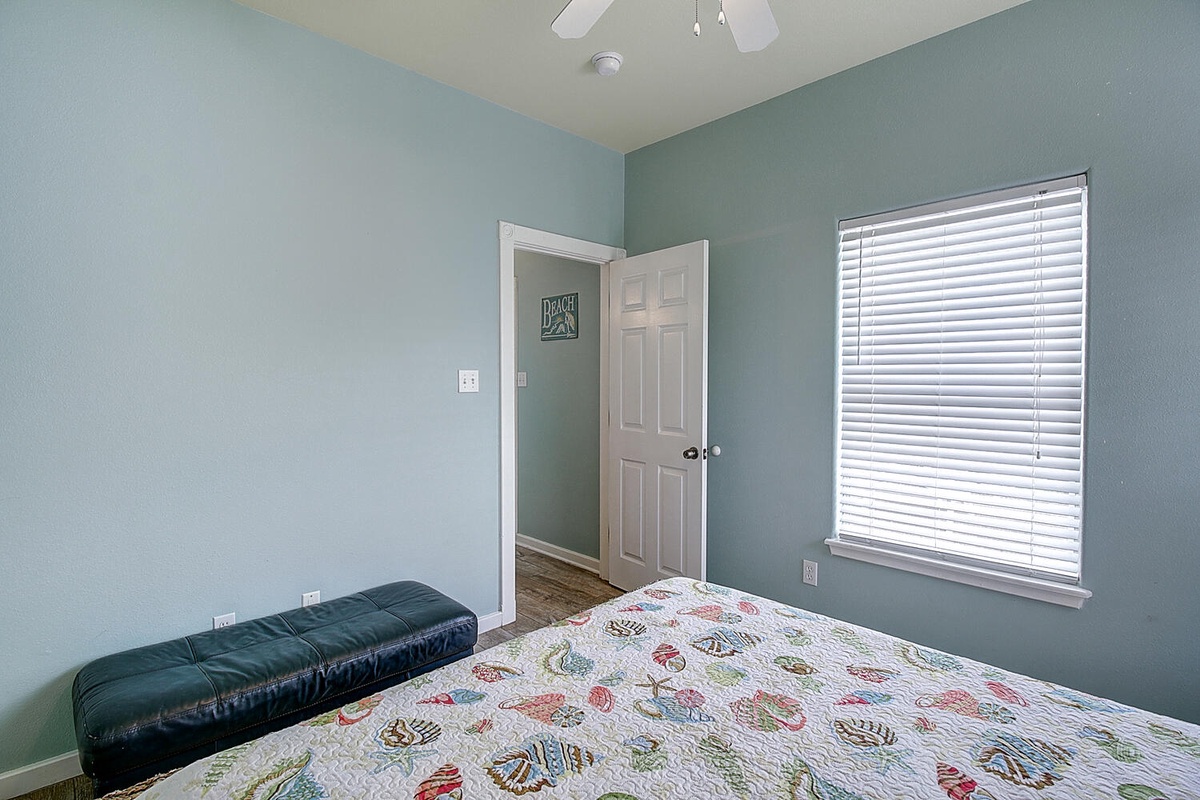 Your peaceful bedroom features soothing sage walls and cheerful bedding, creating the perfect retreat for restful nights.