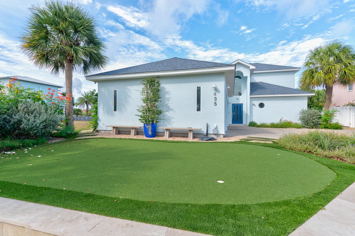 This coastal retreat features a private putting green surrounded by tropical landscaping—perfect for practicing your swing under sunny skies.