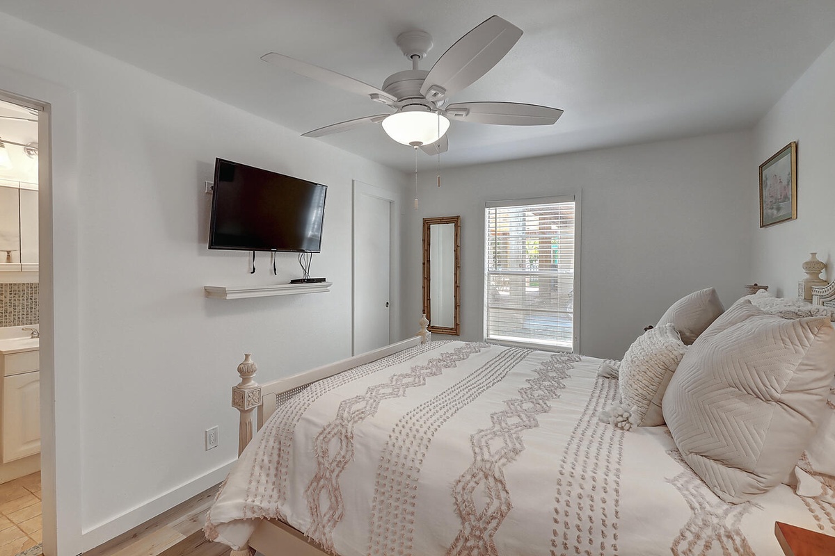 Drift off in your serene bedroom with crisp linens, gentle ceiling fan, and calming neutral tones creating the perfect retreat.