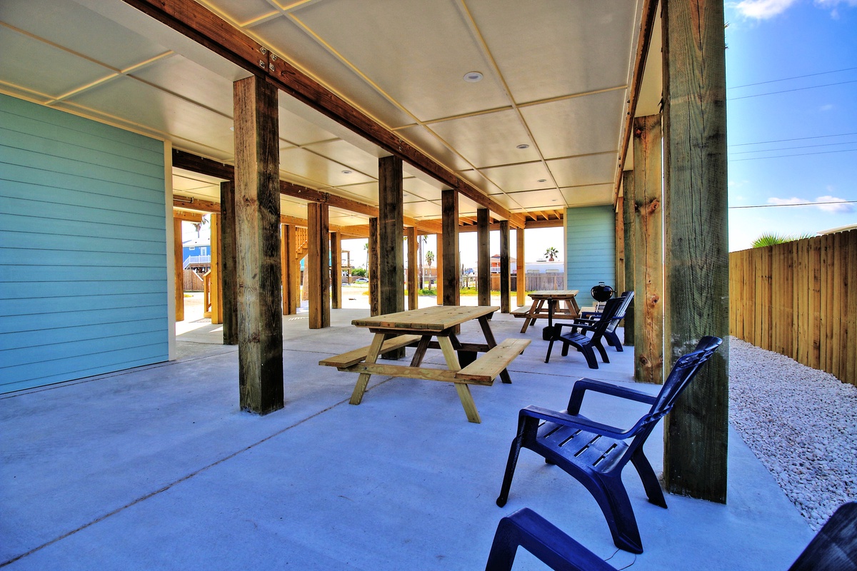 Relax in your covered outdoor sanctuary with picnic table seating and Adirondack chairs, perfect for morning coffee or evening conversations.