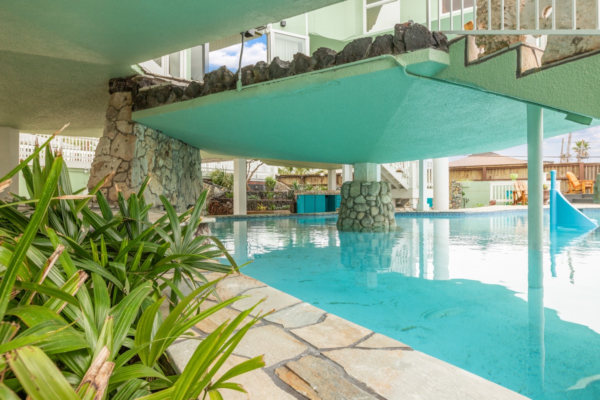 Dive into your private oasis with crystal-clear turquoise waters and natural stone features creating the perfect tropical escape.
