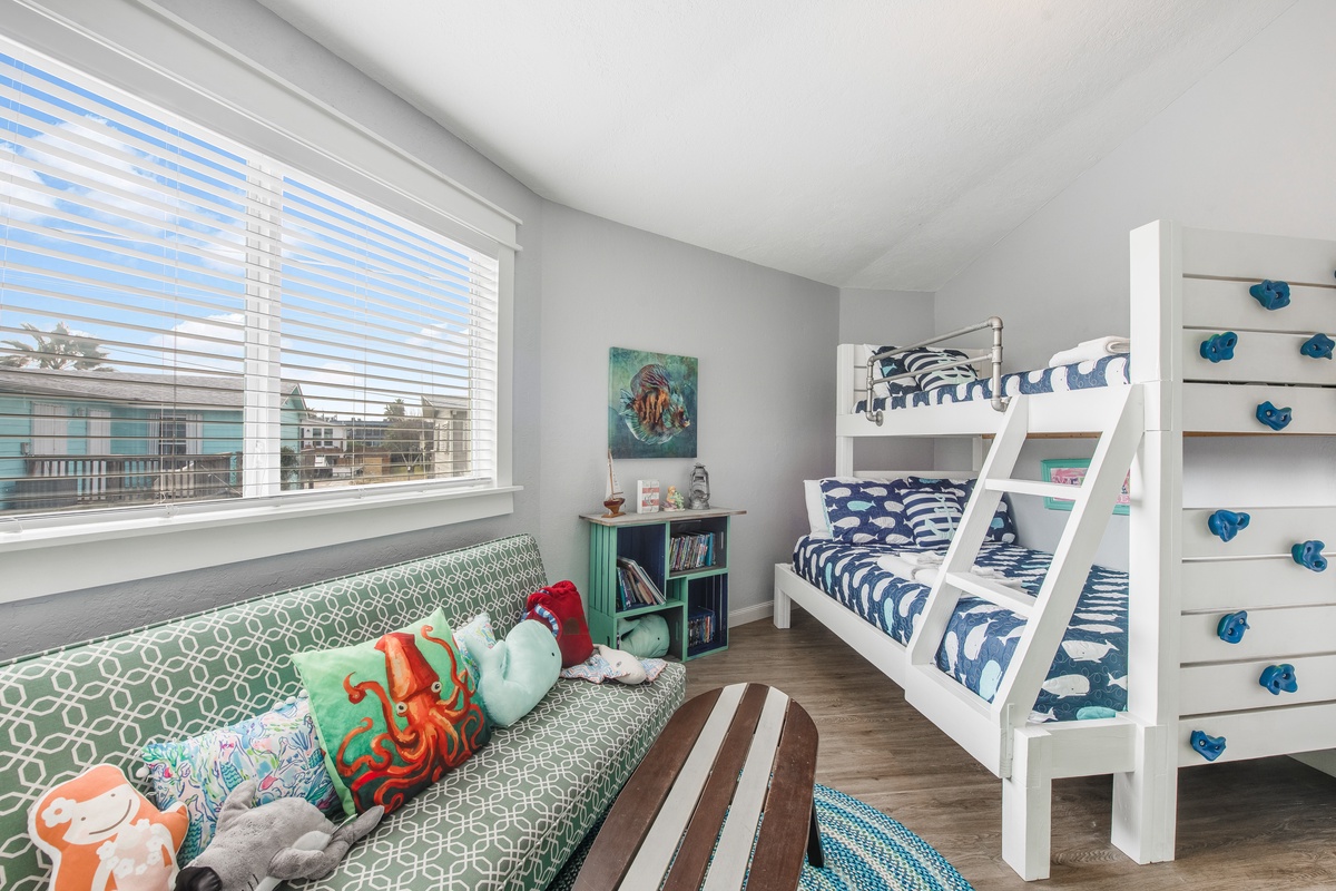 Your kids will love this bright, ocean-themed bedroom with comfy bunk beds and a cozy reading corner by the window.