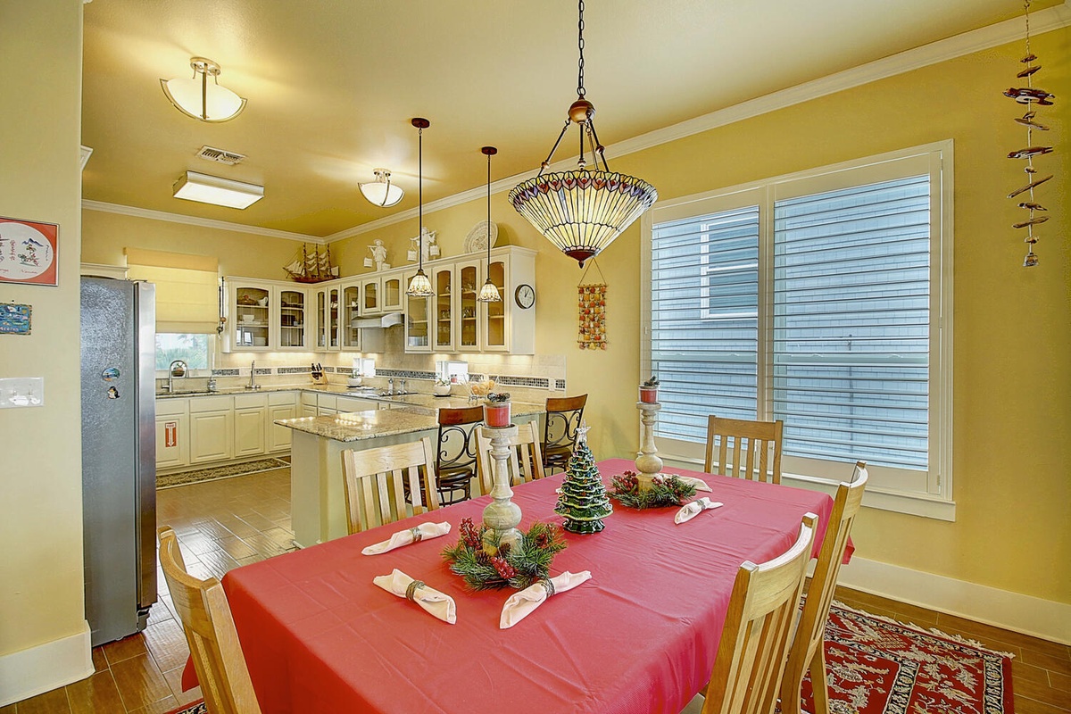 Gather around your elegant dining table for memorable meals, with sparkling chandelier overhead and fully equipped kitchen nearby.