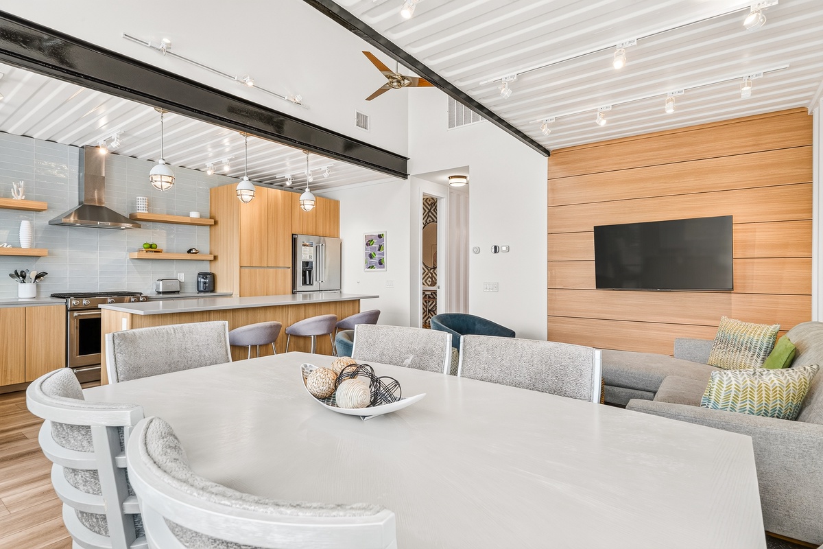 Step into your bright, open living space where modern design meets comfort. Gather around the dining table for meals, relax on the plush sofa, or prepare your favorite dishes in the fully-equipped kitchen.