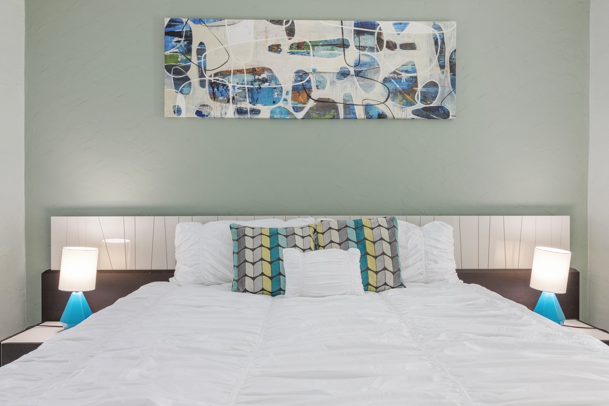 Sink into your comfortable bed with crisp linens and modern artwork creating a soothing retreat for restful nights.