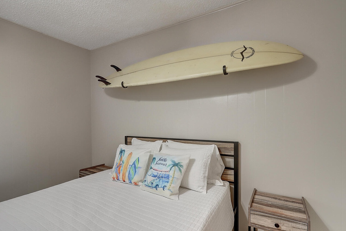 Drift off surrounded by coastal charm, where surfboard wall art and beach-themed pillows create your perfect seaside sanctuary.