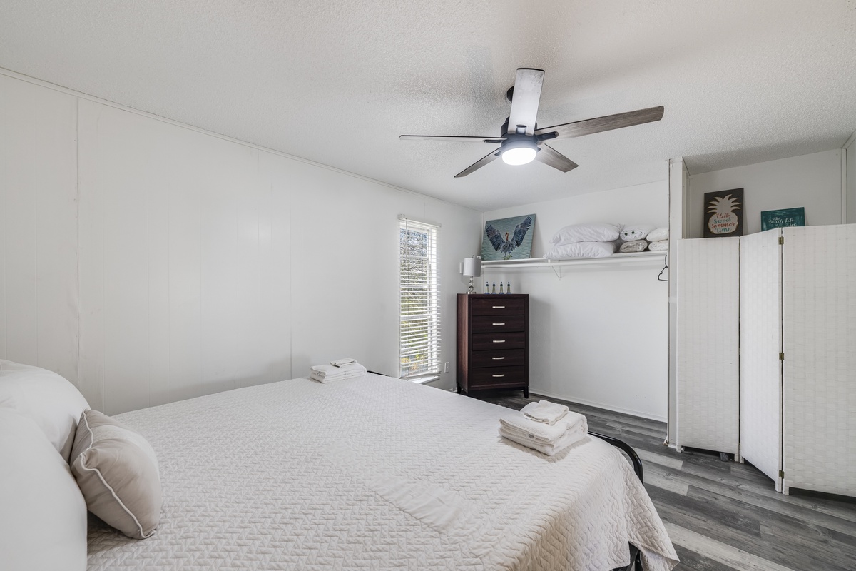 Unwind in your peaceful bedroom featuring plush linens, modern ceiling fan, and thoughtful touches that make this space your home away from home.