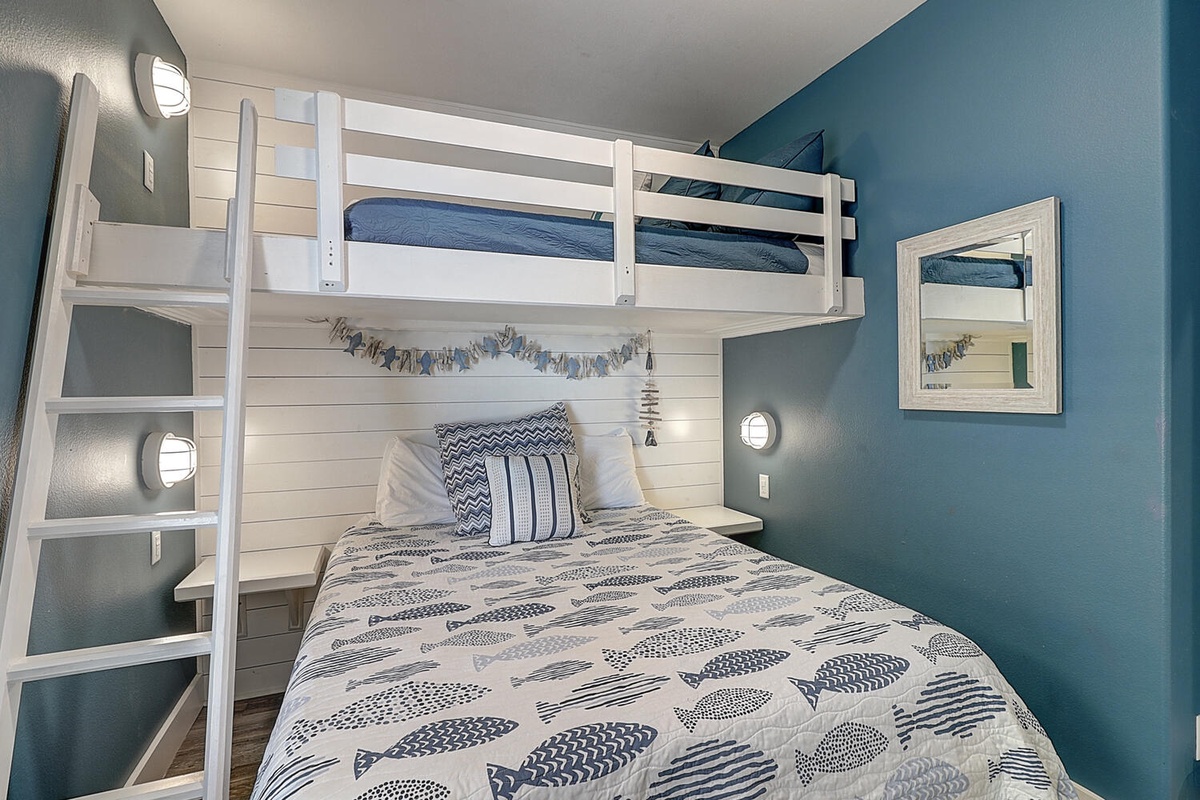 Your kids will love this charming bunk bed setup with coastal decor and built-in reading lights for bedtime stories.
